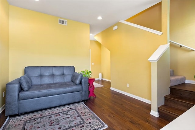 living area featuring visible vents, baseboards, recessed lighting, wood finished floors, and stairs