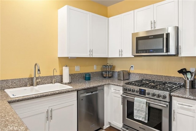 kitchen featuring a sink, white cabinetry, and stainless steel appliances