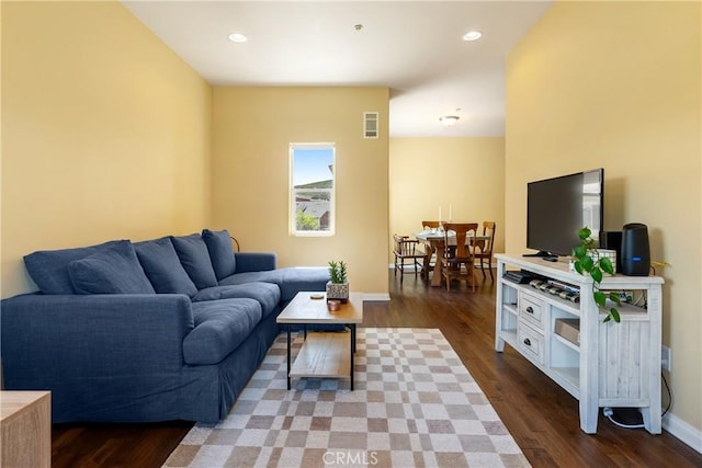 living area with recessed lighting, visible vents, baseboards, and wood finished floors