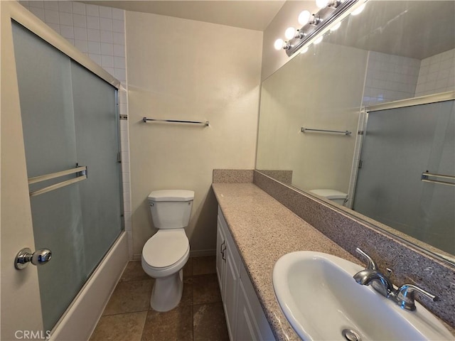 2231 Cedar St Unit G, Alhambra, CA 91801 - bathroom with toilet, vanity, tile patterned floors, combined bath / shower with glass door, and baseboards