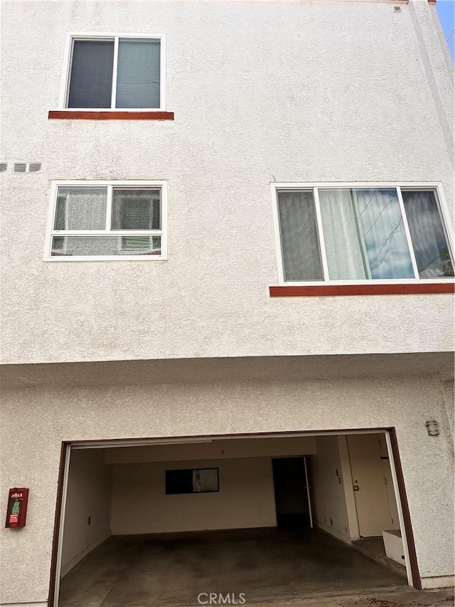 2231 Cedar St Unit G, Alhambra, CA 91801 - view of side of property featuring stucco siding and an attached garage