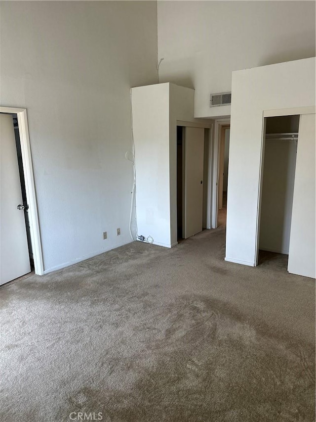2231 Cedar St Unit G, Alhambra, CA 91801 - unfurnished bedroom with carpet, two closets, and a towering ceiling