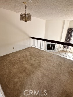 2231 Cedar St Unit G, Alhambra, CA 91801 - unfurnished room featuring carpet floors, a textured ceiling, and a chandelier