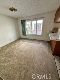 2231 Cedar St Unit G, Alhambra, CA 91801 - unfurnished dining area featuring light carpet and a textured ceiling