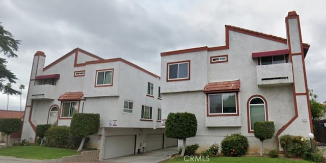 2231 Cedar St Unit G, Alhambra, CA 91801 - view of front of home featuring a garage, stucco siding, driveway, a chimney, and a front yard