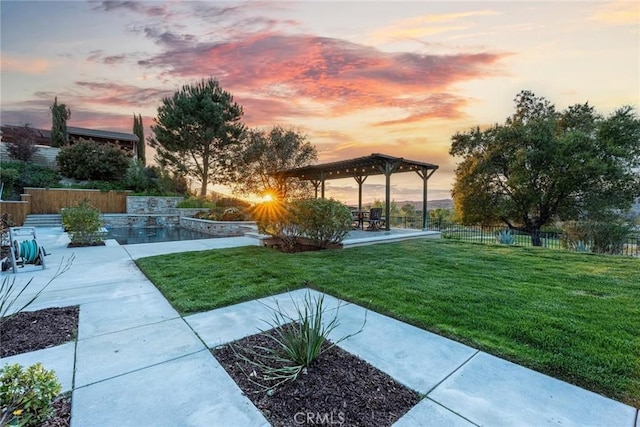 yard at dusk with a pergola, fence, and a patio