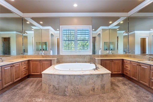 full bath with two vanities, a sink, ornamental molding, and a tub with jets