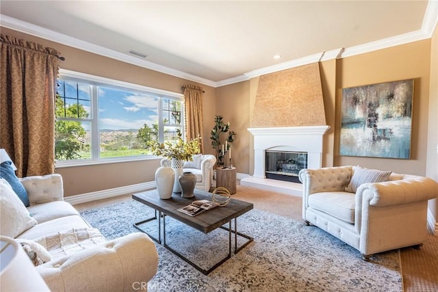 living room featuring baseboards, crown molding, carpet flooring, and a large fireplace