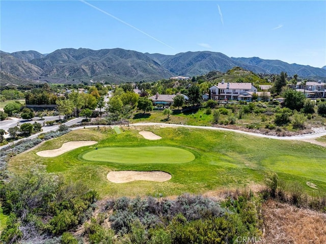 view of home's community with a residential view, a mountain view, and golf course view