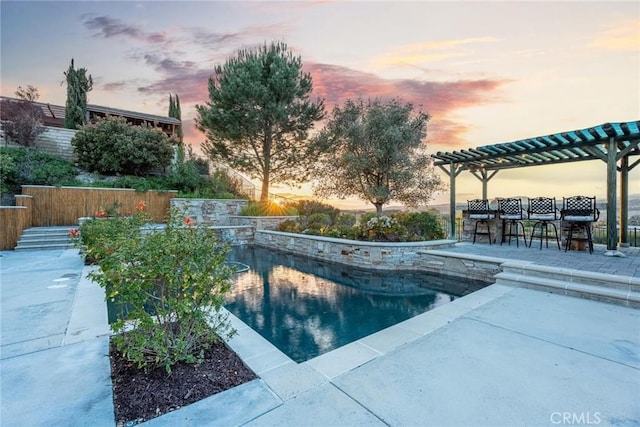 pool at dusk featuring an outdoor pool, outdoor dry bar, a pergola, and a patio area