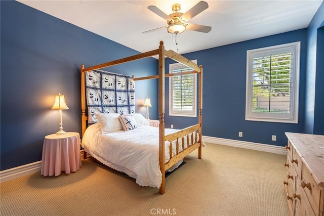 carpeted bedroom with ceiling fan and baseboards