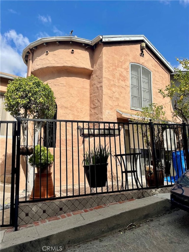 exterior space featuring fence and a gate