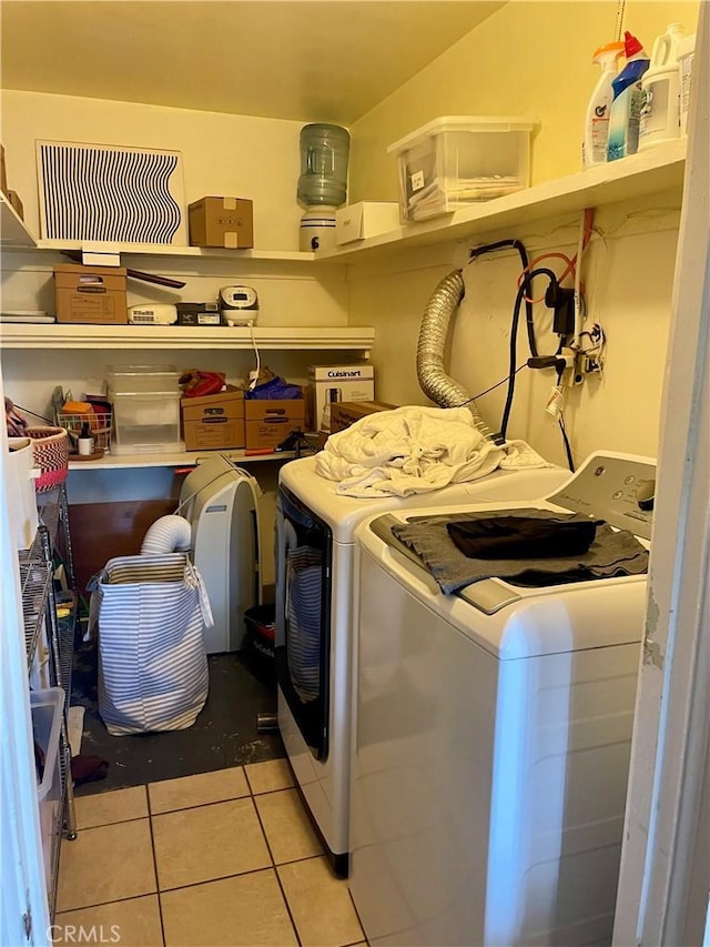 laundry room featuring light tile patterned floors, separate washer and dryer, and laundry area
