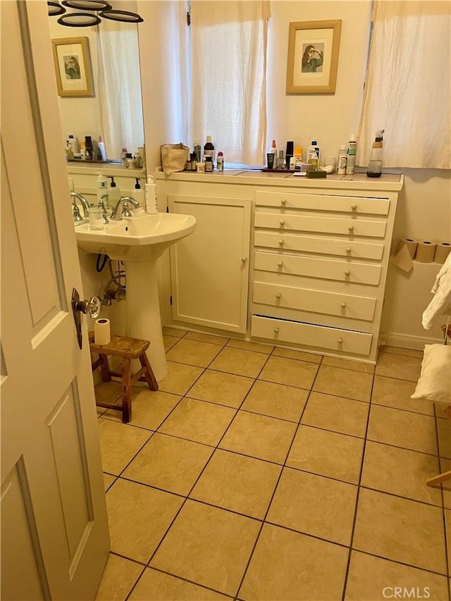 bathroom with tile patterned floors and a sink