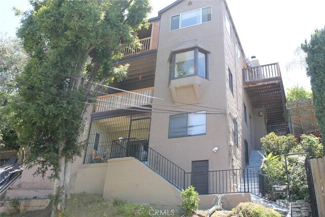 2859 Effie St, Los Angeles, CA 90026 - back of property with stairs, stucco siding, and a balcony