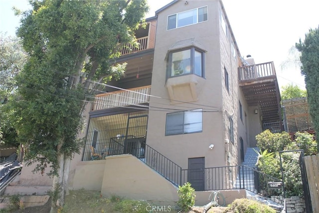 2859 Effie St, Los Angeles, CA 90026 - rear view of property featuring stairway, stucco siding, and a balcony