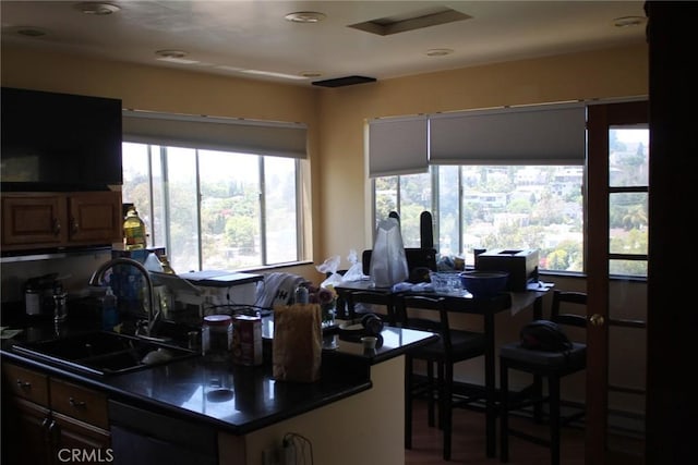 2859 Effie St, Los Angeles, CA 90026 - kitchen featuring a sink, dark countertops, black dishwasher, wood finished floors, and recessed lighting