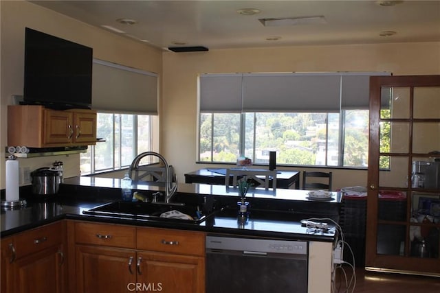 2859 Effie St, Los Angeles, CA 90026 - kitchen featuring dishwasher, healthy amount of natural light, dark countertops, and brown cabinets