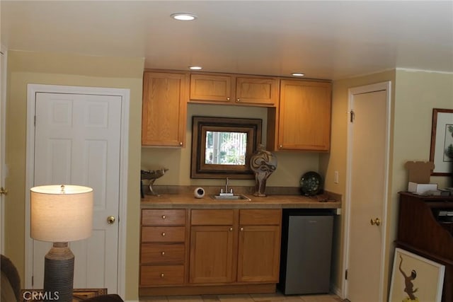 2859 Effie St, Los Angeles, CA 90026 - kitchen with dishwashing machine, recessed lighting, tile countertops, and brown cabinetry