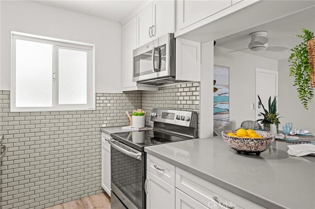 15 15th St Unit 6, Hermosa Beach, CA 90254 - kitchen with stainless steel appliances, white cabinets, ceiling fan, light countertops, and light wood finished floors