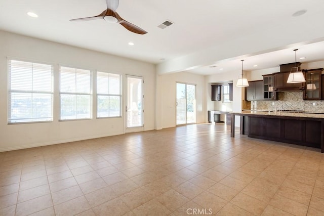 unfurnished living room with visible vents, baseboards, light tile patterned floors, a ceiling fan, and recessed lighting