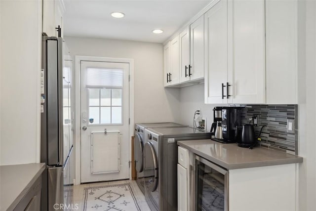 washroom featuring wine cooler, separate washer and dryer, laundry area, and recessed lighting