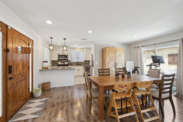 dining space with recessed lighting, visible vents, and dark wood-type flooring