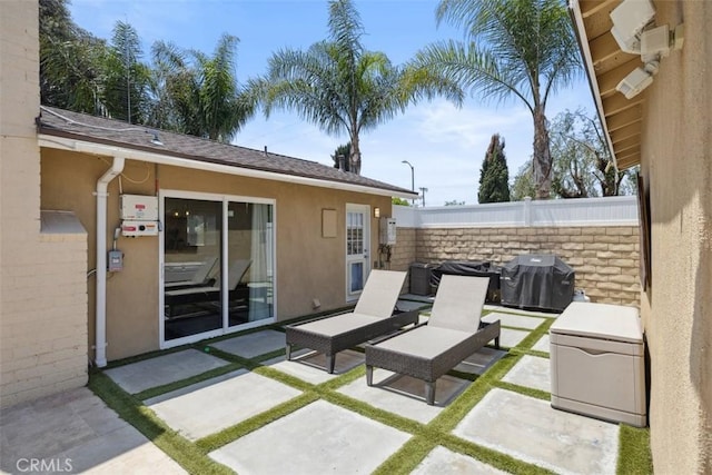 view of patio / terrace featuring fence and grilling area