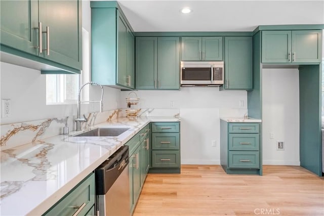 14320 Osborne St, Panorama City, CA 91402 - kitchen featuring stainless steel appliances, a sink, green cabinetry, light wood-type flooring, and recessed lighting