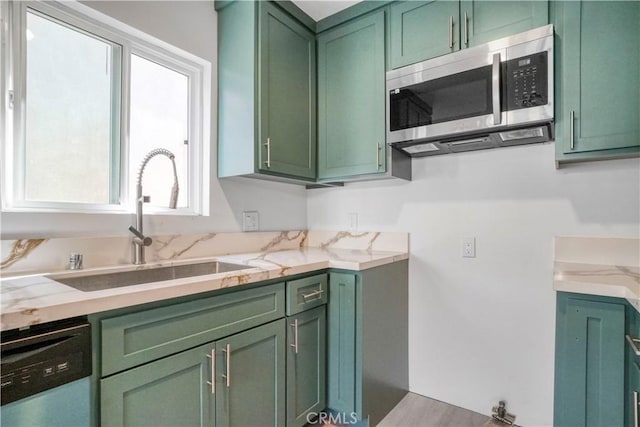 14320 Osborne St, Panorama City, CA 91402 - kitchen featuring green cabinets, appliances with stainless steel finishes, a sink, and light stone countertops