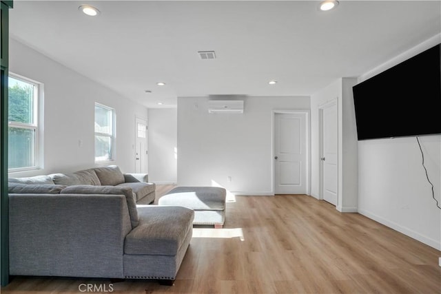 14320 Osborne St, Panorama City, CA 91402 - living room featuring a wall mounted AC, light wood-style floors, recessed lighting, and baseboards