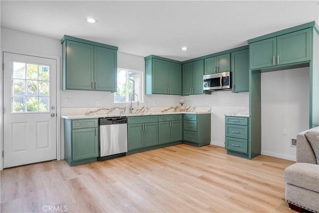 14320 Osborne St, Panorama City, CA 91402 - kitchen with appliances with stainless steel finishes, a sink, light wood-style flooring, light countertops, and recessed lighting