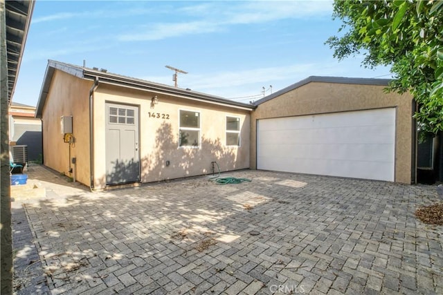 14320 Osborne St, Panorama City, CA 91402 - view of front facade featuring stucco siding, a garage, and driveway