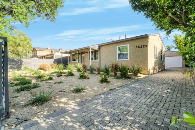 14320 Osborne St, Panorama City, CA 91402 - ranch-style home featuring stucco siding and an outbuilding