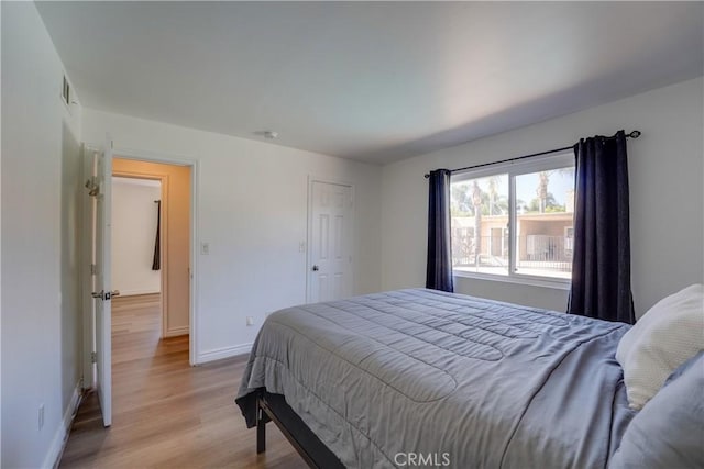 1386 E Madison Ave Unit 21, El Cajon, CA 92021 - bedroom with visible vents, baseboards, and light wood finished floors