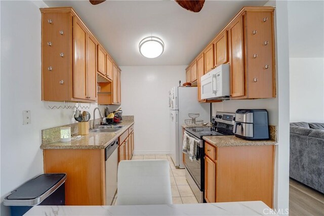 1386 E Madison Ave Unit 21, El Cajon, CA 92021 - kitchen with light stone counters, a sink, and stainless steel appliances