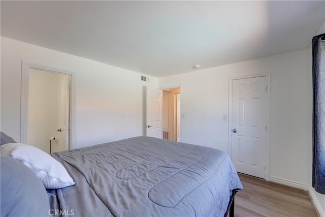 1386 E Madison Ave Unit 21, El Cajon, CA 92021 - bedroom with light wood-style floors, baseboards, and visible vents