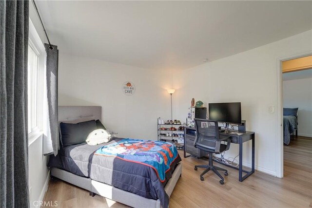 1386 E Madison Ave Unit 21, El Cajon, CA 92021 - bedroom with light wood-style floors, baseboards, and multiple windows