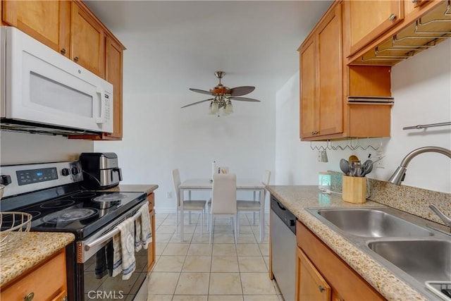 1386 E Madison Ave Unit 21, El Cajon, CA 92021 - kitchen with appliances with stainless steel finishes, light tile patterned flooring, brown cabinetry, ceiling fan, and a sink