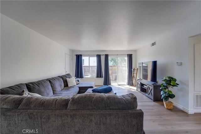 1386 E Madison Ave Unit 21, El Cajon, CA 92021 - living room featuring light wood-style floors, baseboards, and visible vents