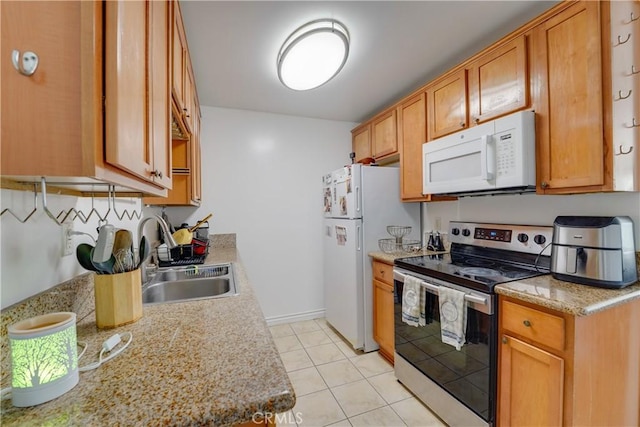 1386 E Madison Ave Unit 21, El Cajon, CA 92021 - kitchen featuring light tile patterned floors, white appliances, brown cabinetry, light countertops, and a sink