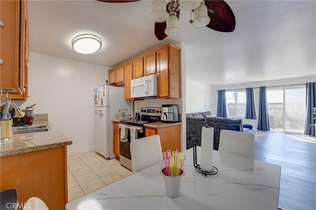 1386 E Madison Ave Unit 21, El Cajon, CA 92021 - kitchen featuring white appliances, open floor plan, a ceiling fan, brown cabinets, and a sink