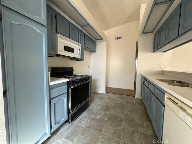 kitchen with light countertops, visible vents, white appliances, baseboards, and a textured ceiling