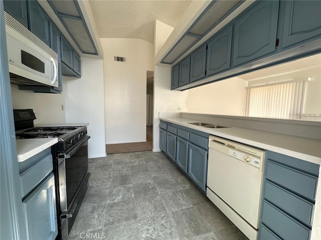 kitchen with blue cabinetry, visible vents, white appliances, and light countertops
