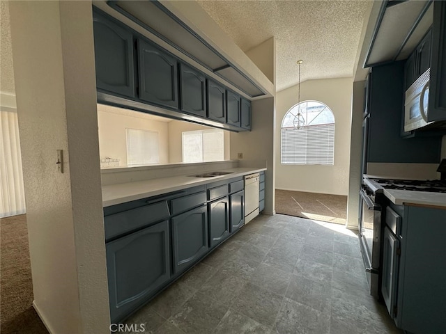 kitchen featuring a textured ceiling, vaulted ceiling, gas stove, dishwasher, and decorative light fixtures