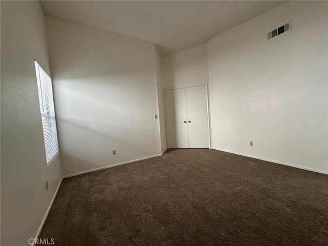 carpeted empty room with baseboards and visible vents