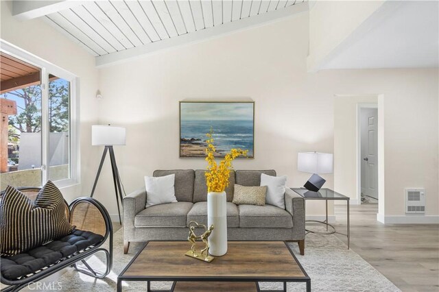 1000 W Macarthur Blvd Unit 106, Santa Ana, CA 92707 - living room with baseboards, light wood-type flooring, heating unit, and beam ceiling