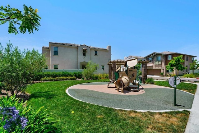 view of play area featuring a yard and a residential view
