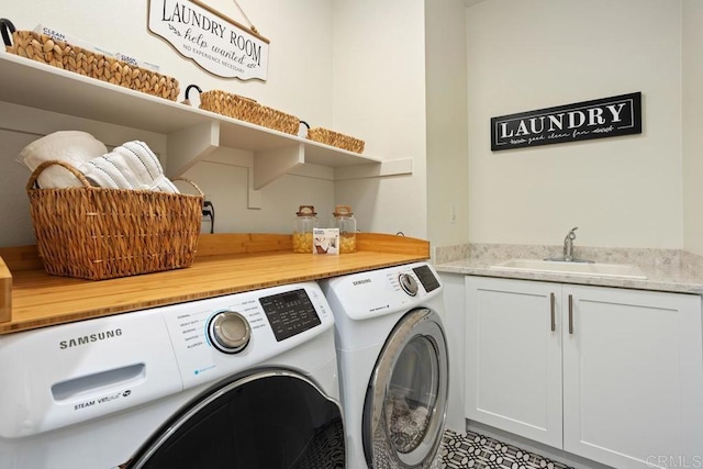 washroom with separate washer and dryer, a sink, and cabinet space
