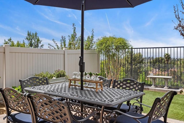 view of patio / terrace with outdoor dining space and fence